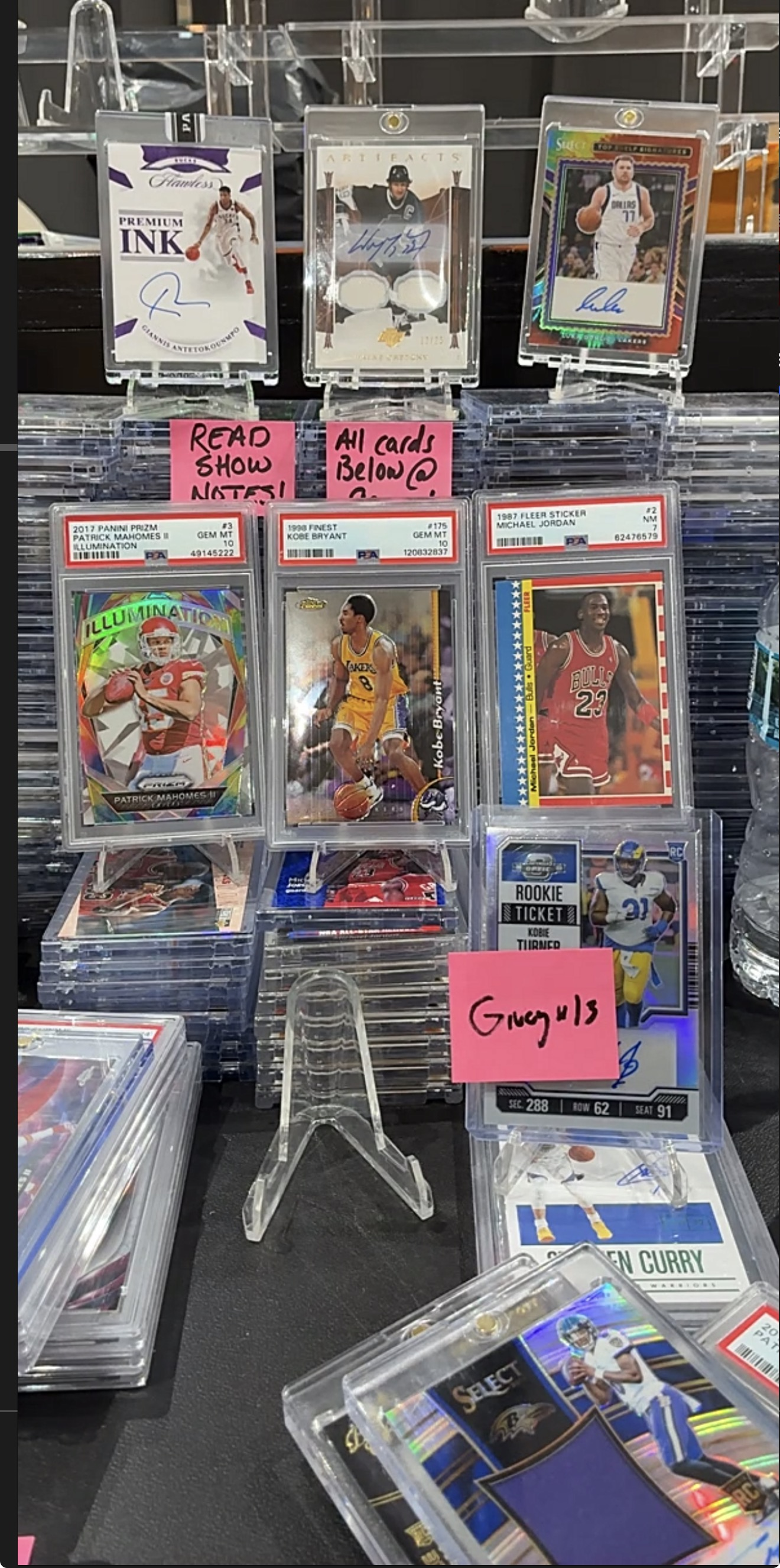 Graded sports cards and autograph cards on display.